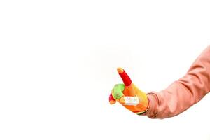 A bright hand with a band aid on a finger isolated against a white background is a great stock photo