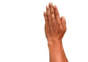 Close-up of a raised human hand with brown skin against a stark white background, creating visual contrast photo