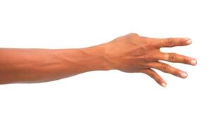 Close-up of a brown-skinned human arm extended with fingers splayed against a white background photo