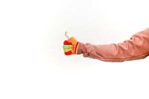 Hand in a Colorful Glove Giving a Thumbs Up on a Clean White Background Image photo
