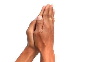 Close-up of two hands pressed together in a prayerful or grateful gesture against a pristine white background photo
