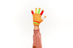 Arm Wearing a Colorful Glove Against a White Background in a Studio Setting photo
