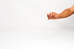 Hand reaching, with clenched fingers, in studio on white background for mockup, presentation, or graphic resource photo