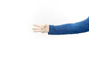 Hand in latex glove gesturing number three against a white background for safety demonstration photo