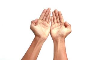 Two hands reaching upwards in prayer or offering, isolated on a white background creating a clean and hopeful image photo