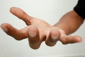 Hand reaching out, offering help, support or showing the need for assistance photo