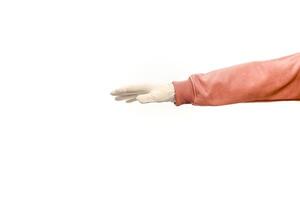 Isolated studio shot of a hand in a latex glove and pink sweater on white background photo