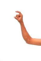 Close-up of Hand Pinching or Holding Something Small Against a White Background photo