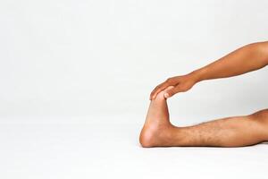 Man practicing the One Legged King Pigeon Pose variation to improve flexibility photo