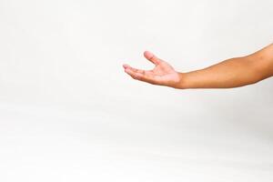 Isolated human arm outstretched with palm up on white backdrop creating space for ideas photo