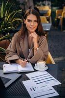 Woman working at a cafe table photo