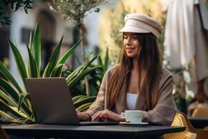 Woman with laptop at an outdoor cafe photo