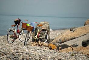 Bicycles Parked on a Rocky Beach with Sea View photo