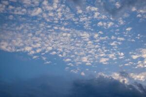 Expansive Sky with Fluffy White and Dark Cloud Formations photo