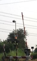 A train crossing with a light pole photo