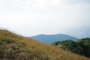 Rainforest summit range and hill ridge with cloudy blue sky photo