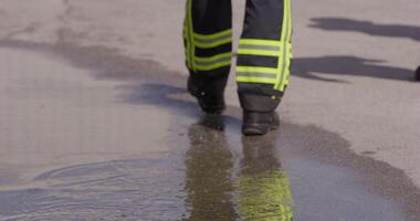 A close-up shot captures the determined stride of a firefighter as they walk towards a firetruck, showcasing their readiness and commitment to respond to an emergency with unwavering dedication video
