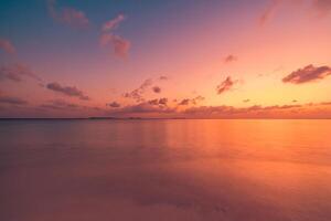 Sunset beach closeup featuring expansive seascape, colorful horizon, and dramatic sky, tranquil tropical shore inspiring dreamy travel, summer getaway sunrise nature escape photo