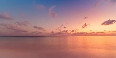 Amazing panoramic sunset seascape with colorful sky and calm sea on the horizon, dreamy ocean view perfect for meditation, inspiration, nature wallpaper, peaceful summer travel background photo