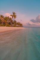 Beautiful tropical sunset beach with palm trees and calm waves, romantic sky and clouds creating an inspiring nature scene, perfect for summer vacation, relaxation, and exotic island escape photo