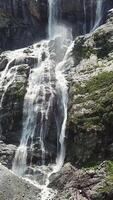 Close-up raging mountain waterfalls. Aerial view of giant waterfall flowing in mountains. Beautiful landscape video