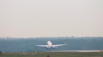 Passenger airplane taking off and climbing, rear view long shot. Airliner fly away. Travel concept video