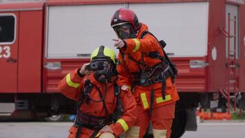A group of specialized firefighters employs a thermal camera to locate and assess dangerous fire areas, demonstrating their advanced technology and expertise in effectively combating high-temperature video