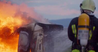 Firefighters fight the fire flame to control fire not to spreading out. Firefighter industrial and public safety concept. Traffic or car accident rescue and help action. video
