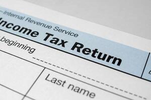 Close-up view of income tax return form. Financial document for filing annual taxes with detailed personal and income information photo