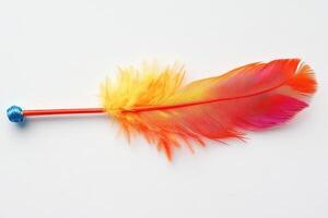 A colorful feather with a blue and orange tip photo