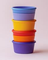 A stack of colorful plastic bowls on a white background. photo