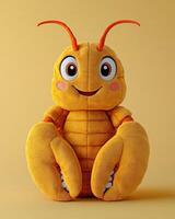 A stuffed toy of a yellow bug sitting on a yellow background photo