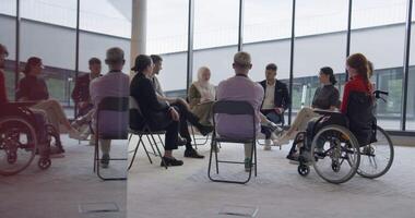 A diverse group of young business entrepreneurs gathered in a circle for a meeting, discussing corporate challenges and innovative solutions within the modern confines of a large corporation video