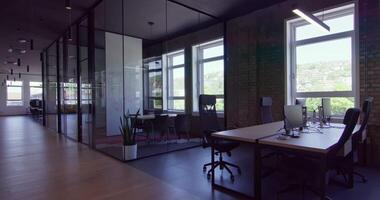 Modern startup centers composed of glass offices within a contemporary corporate environment, highlighting the sleek, innovative, and minimalist design aesthetics of a cutting-edge workspace video