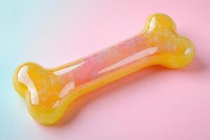A yellow and pink dog bone on a pastel background photo