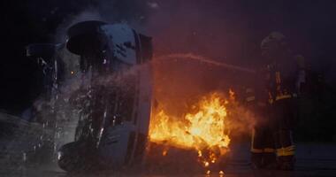 Firefighters fight the fire flame to control fire not to spreading out. Firefighter industrial and public safety concept. Traffic or car accident rescue and help action. video
