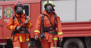 A group of prepared firefighters stands ready for hazardous tasks involving rescuing victims and extinguishing fires, exemplifying their dedication and bravery in the face of emergencies video