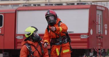 A group of specialized firefighters employs a thermal camera to locate and assess dangerous fire areas, demonstrating their advanced technology and expertise in effectively combating high-temperature video