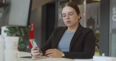 A disappointed woman in a wheelchair using a smartphone in a modern office, highlighting the importance of accessibility and inclusivity in the workplace, despite the challenges she faces video