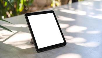 Plain Black Tablet On Concrete photo