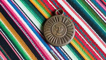 Mayan Seal Fragment On Guatemalan Textile photo