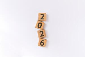 New year 2026 concept. 2026 written on wooden blocks arranged vertically. New year's resolution. photo