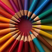 A vibrant and colorful array of drawing pencils arranged in a circular pattern forming a visually appealing spectrum of hues photo
