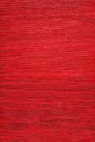 Detailed shot showing a textured background, featuring vibrant red hues, with fine lines and subtle gradients. photo