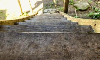 A wooden staircase with a wooden railing photo
