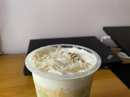 A drink with a white topping photo