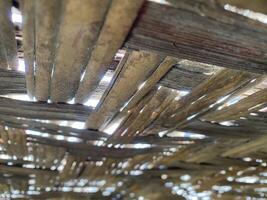 A wooden ceiling with a wooden beam photo