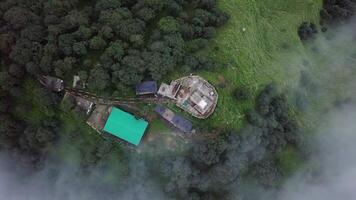 A stunning aerial view of a peaceful landscape with structures nestled in the mountains. Stock Clip video