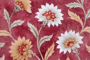 Floral jaal pattern featuring intricate designs with vibrant colors, showcasing a blend of white and yellow flowers against a rich red background, ideal for textile and wallpaper applications photo