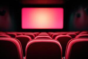 Red theater seats arranged in rows facing a large blank screen, creating an inviting atmosphere for moviegoers to enjoy cinematic experiences in a modern cinema photo
